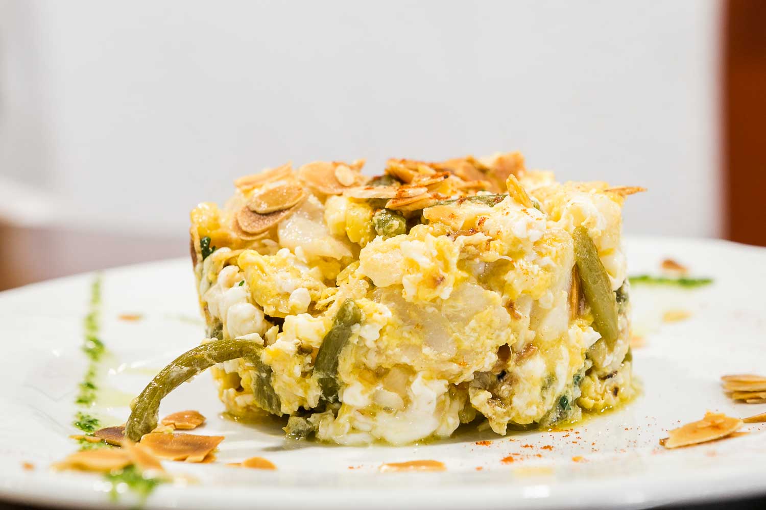 Scrambled eggs with tender garlic, cod and almonds