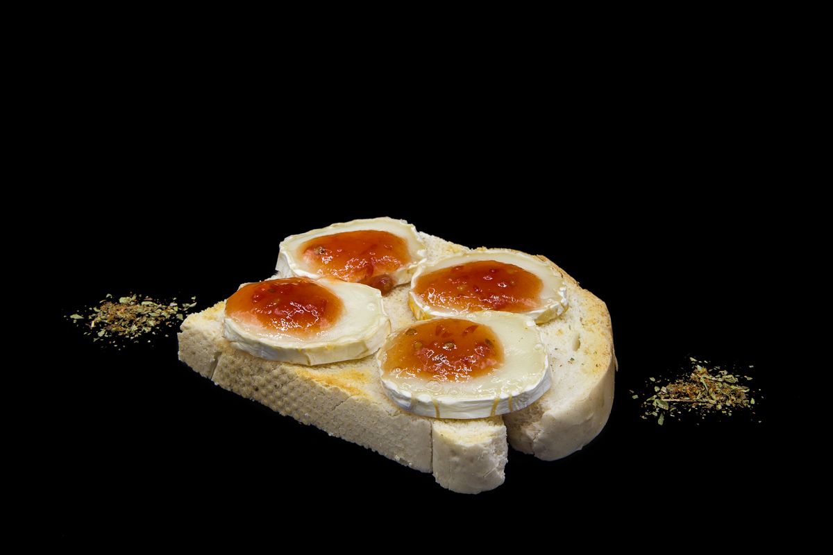 Toast with slices of goat cheese and tomato marmalade