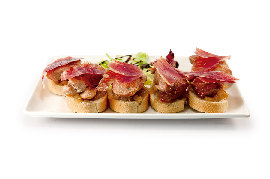 Grilled pork medallions with Iberian ham over toast