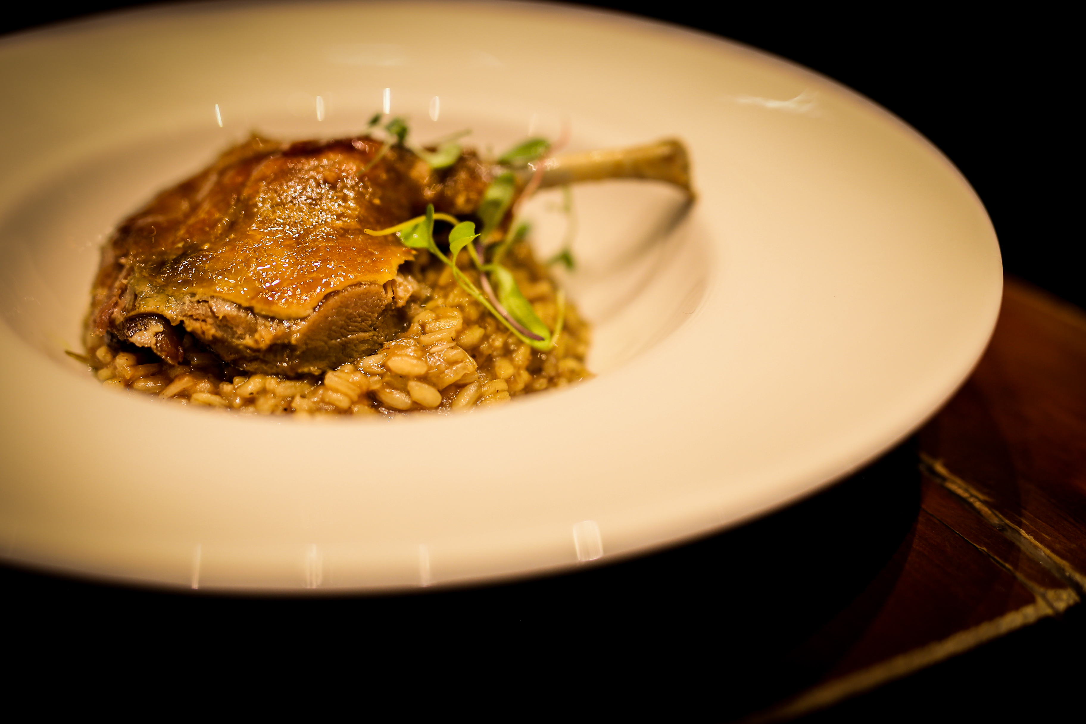 Duck confit on its creamy rice and dried tomato