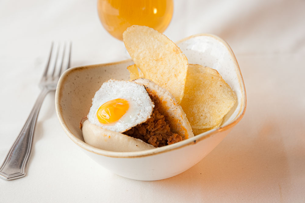Bao bread montadito with chistorra, onion, and quail egg