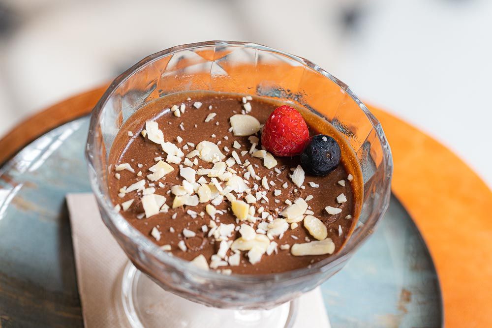 Homemade Dark Chocolate Mousse with chopped hazelnuts and raspberries