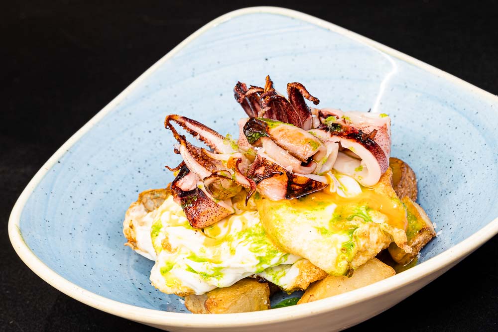 Fried eggs with grilled baby squid and green sauce