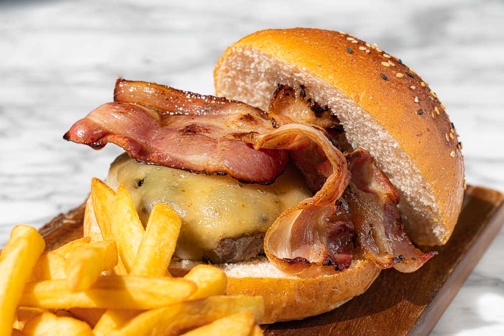 Beef burger with melted cheese and bacon