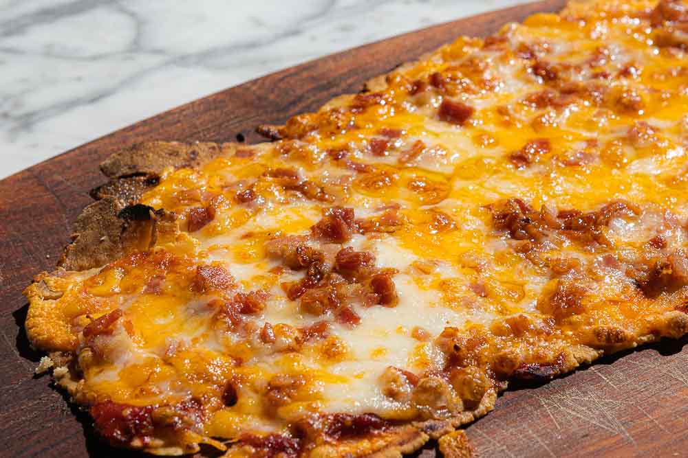 Four cheese pizza with bacon