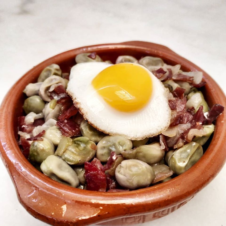 Broad beans, ham and fried quail egg pot