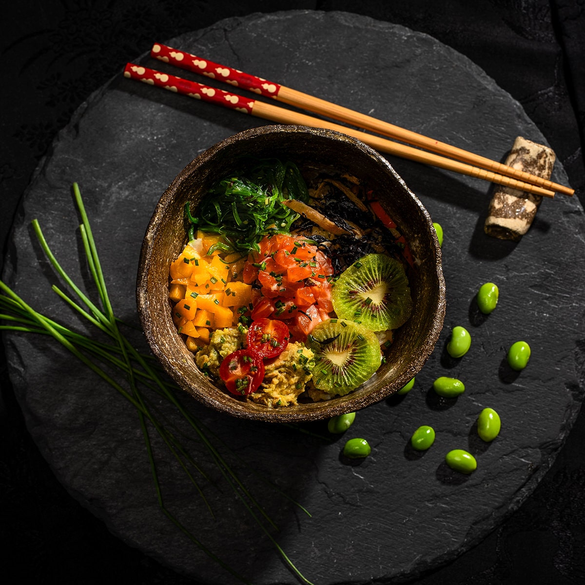 Poke bowl of rice with fish, vegetables and seaweed